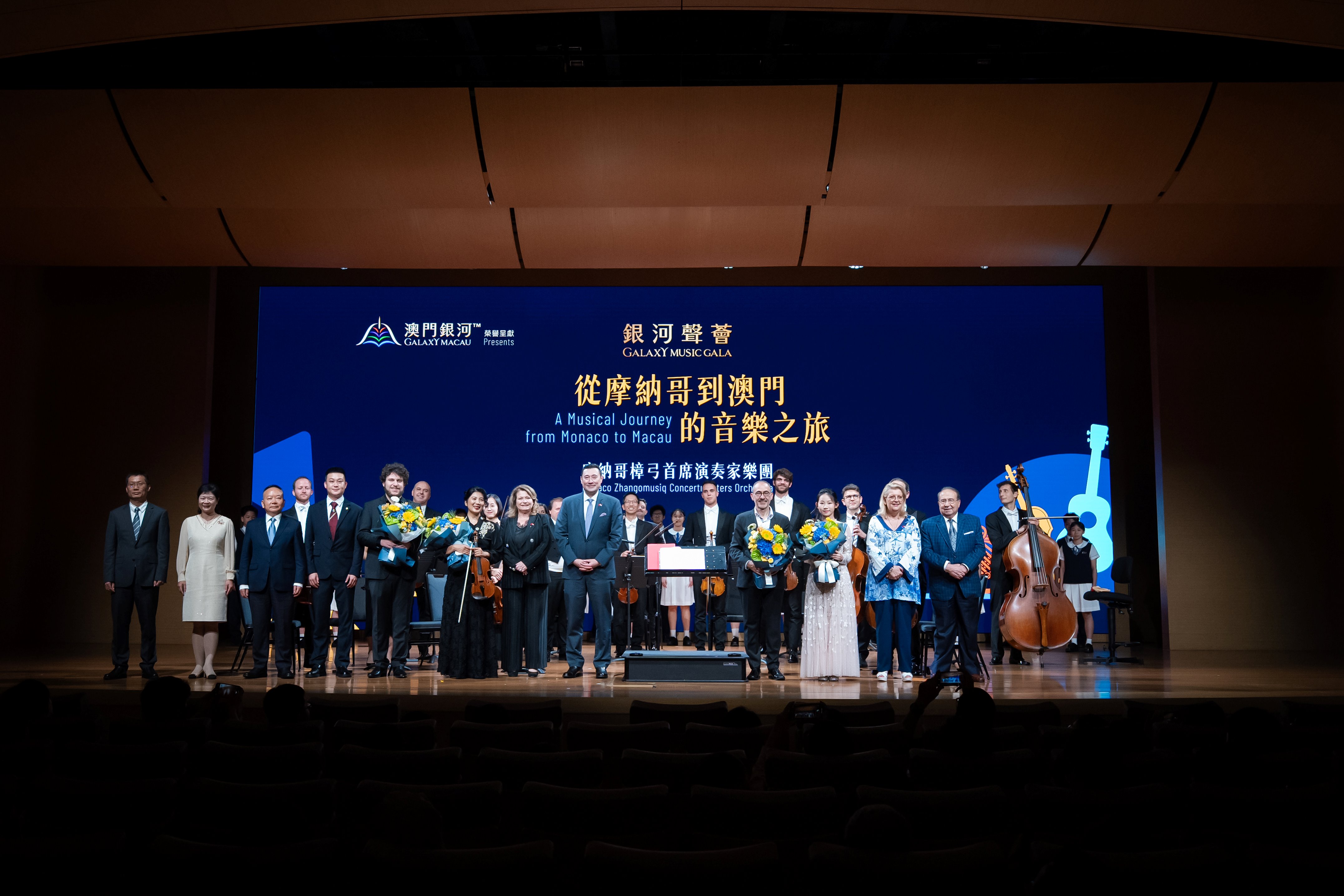 Mr. Troy Hickox, Head of Hotels & Lifestyle Development of Galaxy Entertainment Group (“GEG”), Director of Monte Carlo Societé des Bains de Mer (SBM), following his introductory address, standing on stage next to H.E. Ms. Marie-Pascale BOISSON.