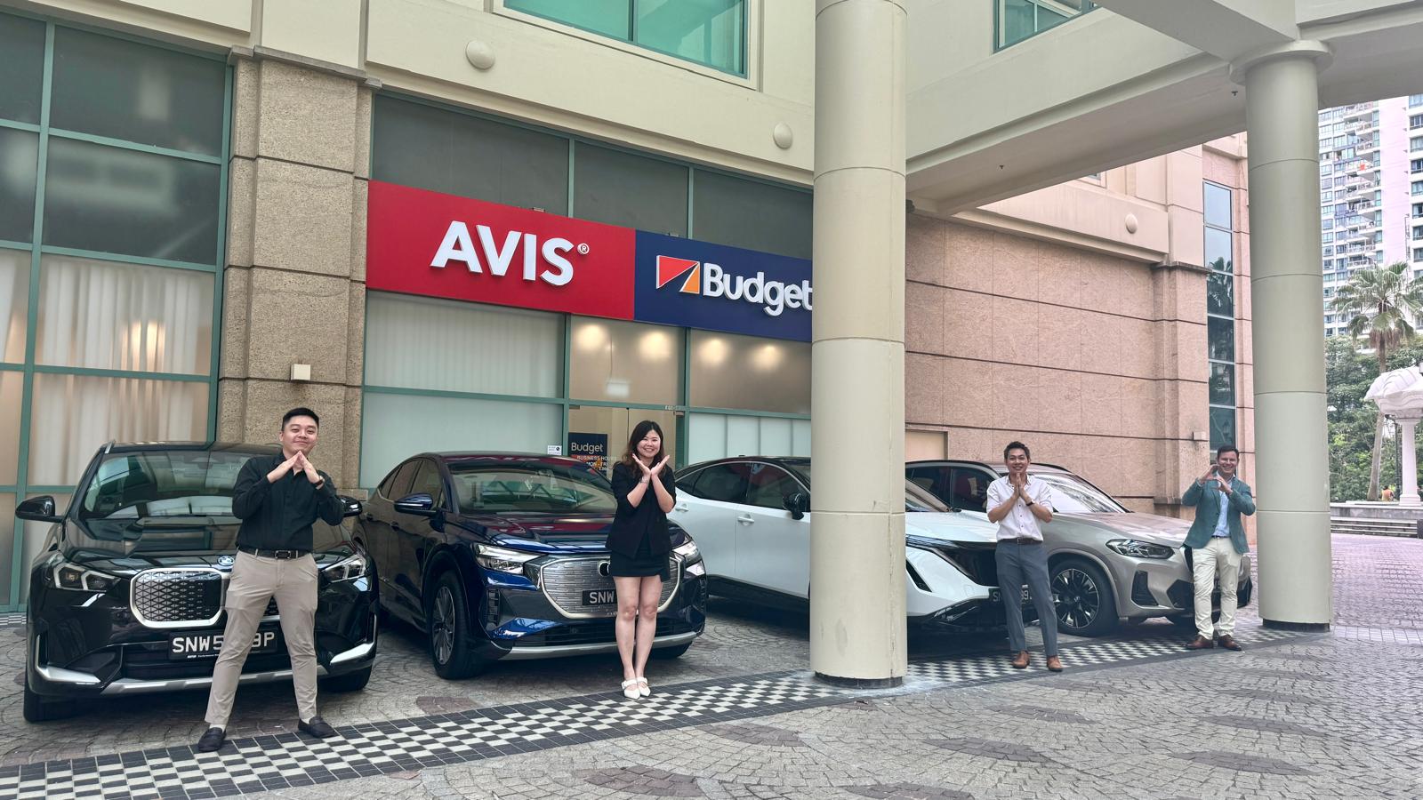AVIS Singapore personnel and their modern fleet, reflecting a commitment to safety, quality, and sustainable mobility solutions.